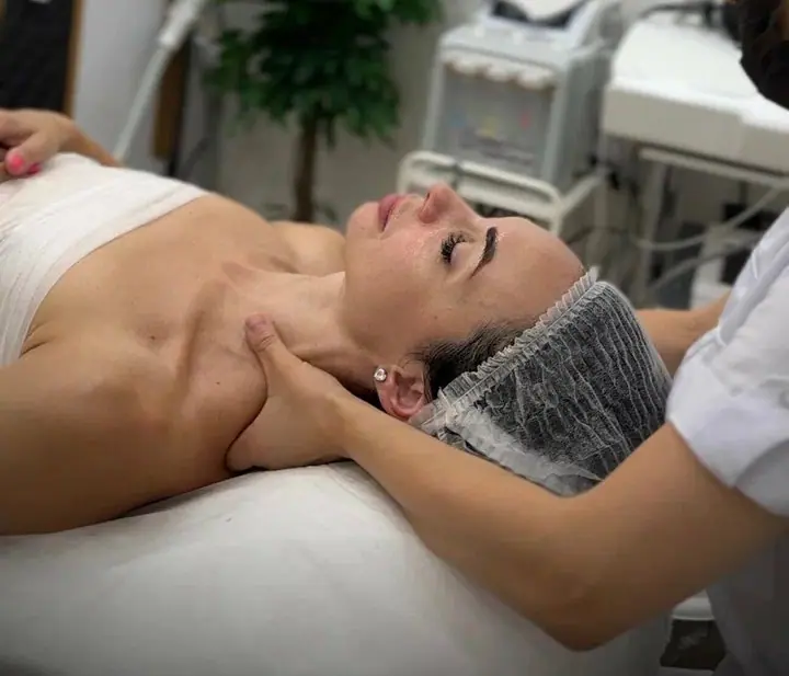 Косметолог делает массаж лица в кабинете D.O.M. Beauty